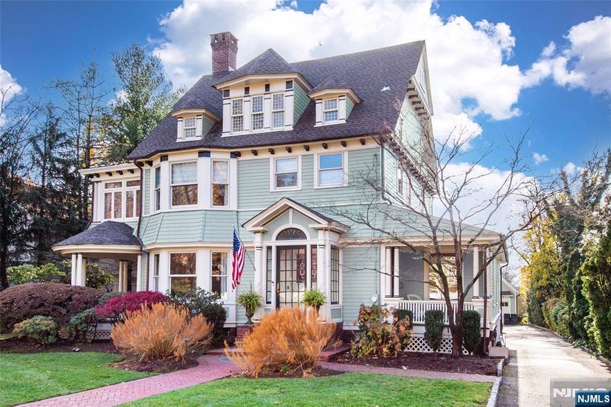 A beautifully updated five-bedroom home in the heart of Ridgewood, designed for effortless living and entertaining. Ideally located near downtown, it offers the perfect blend of tranquility and convenience. A welcoming foyer opens to a spacious living room with fireplace and a bright dining room. Filled with natural light and professionally decorated, the home features multiple inviting living areas and exceptional architectural flow. The renovated oversized kitchen is the true centerpiece, showcasing vaulted ceilings, abundant light, custom cabinetry, and a generous center island for gathering. It opens seamlessly to an outdoor patio with a fireplace, ideal for entertaining or relaxing year-round. A family room/den just off the kitchen includes a powder room and built-in desk area. Charming side porches and a back porch extend the living space outdoors. The primary suite features a renovated bath and flexible side room for a home office, dressing area, or private retreat. Two bedrooms share a hall bath, while the third floor offers two additional bedrooms and a full bath, perfect for guests, teens, or workspace. The finished lower level includes a recreation room, gym area, laundry, and full bath. With a deep yard, detached garage, new roof, and freshly painted exterior, this move-in ready home blends classic charm with modern updates. A commuterâ€™s dream, just moments from the train, restaurants, and top-rated schools.