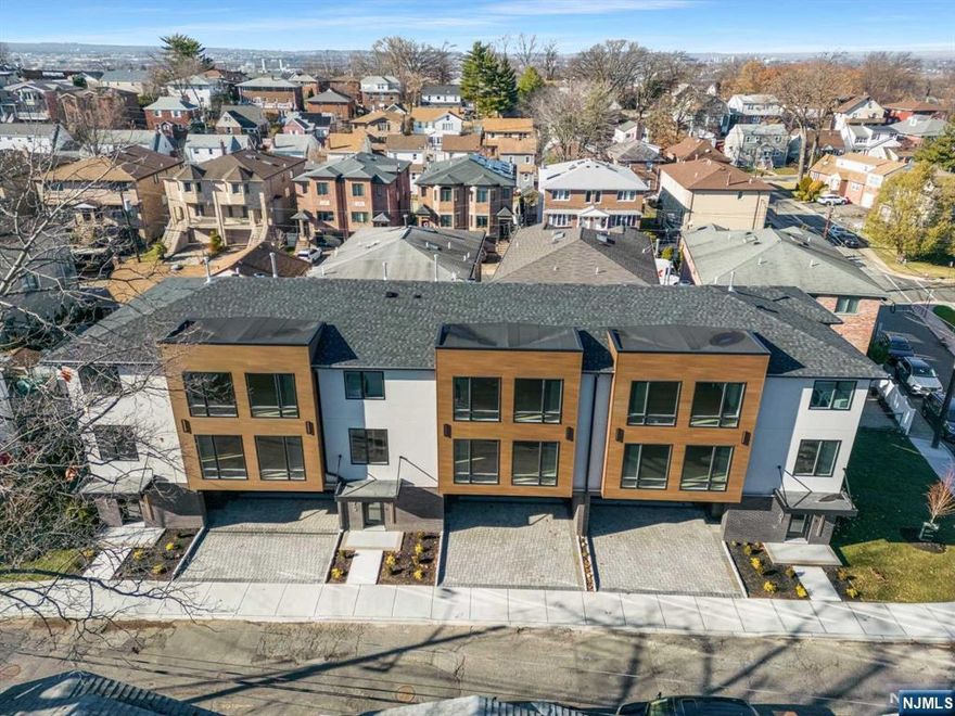 Experience luxury at 771 Jefferson Avenue, Cliffside Park located in the desirable north section bordering Fort Lee. This impressive 3,300+/- sf three story townhouse boasts 9' first floor ceilings, spacious LR, Dining Room, Chef's kitchen w/outdoor deck, powder room, family room, wall unit, fireplace, wet bar w/beverage refrigerator, linen and wine closet. On the 2nd floor you'll find all three bedrooms, laundry room and linen closet. The primary suite features 2 walk in closets, primary bath stuns with dual vanity, skylight, multiple shower streams and LED lighting. The other 2 large bedrooms one with a WIC, share a bathroom. Ground level offers true 2 car garage, 19 feet wide foyer, entry closet and mudroom that leads downstairs to playroom or office with 10' ceilings and full bath w/ sliding glass doors to side yard. Don't be late to this rare oversized horizontal townhouse.