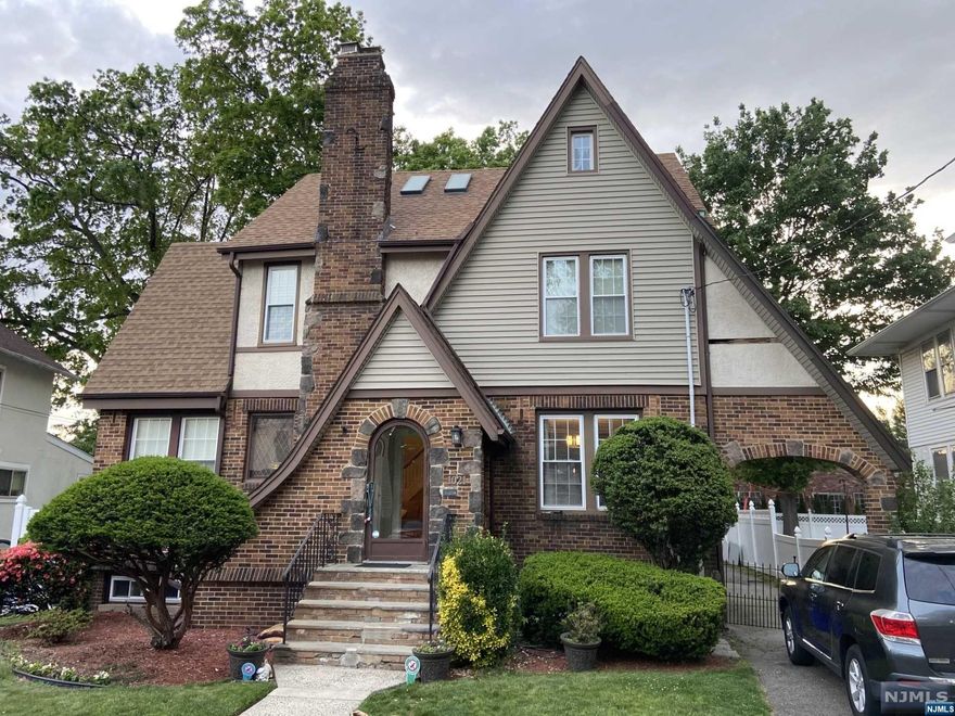 This beautiful Tudor style home has all of the charm plus modern upgrades and stylish renovations. The 3rd floor boasts a large, bright and airy primary suite complete with extra room, skylights and full bath. All brand new! All living spaces are large with high ceilings and beautiful wood trim. Hardwood floors throughout, large 2-car garage, basement with high ceilings, fenced in yard. Quiet street in lovely neighborhood. Close to parks, desirable school #4 and public transportation.