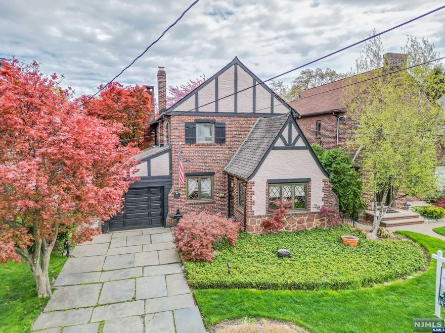 Exquisite English Tudor style home w charm, custom details, & elegance abound. This beautiful property features 4 bdrms, family rm addition w cozy fpl, mstr bdrm addition w FullBA & WIC, spiral staircase to partially fin attic & a fin basement. As you approach the home, you'll be greeted by the warmth & character of the Tudor style, with its beautiful stone and brick exterior. The interior of the home is equally stunning, w custom details throughout, includ beautiful woodwork, built-ins, and decorative moldings. The main floor features a foyer to greet you to open floor plan w living rm, adjacent dining rm and added family rm perfect for entertaining . The kitchen has plenty of counter space and cabinets for storage. Enchanted yard w blue slate, maple trees & fenced-in for privacy. The property is located on a dead-end street and near NY public bus and highways, making commuting a a breeze. Come see for yourself and experience the charm and elegance of this beautiful Tudor home!