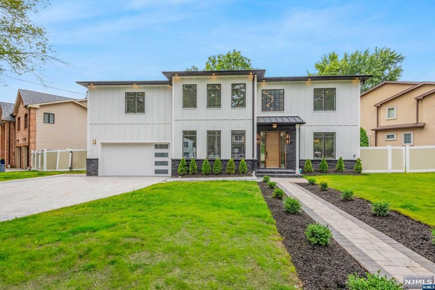 On NEW FOUNDATION. Indulge in the epitome of luxury living with this exquisite modern masterpiece, boasting 6 bedrooms, 5.5 bathrooms, and a generous 5500 square feet of living space. Step into the dramatic 2-story foyer, it's clear that no detail has been overlooked, with custom woodwork throughout and designer cabinetry and luxury appliances in the kitchen, complete with a grand island for entertaining. Upstairs, the primary suite is a tranquil oasis, featuring custom closets and a spa-like bathroom with a soaking tub, double vanities, and rainfall shower. Fully finished basement includes a movie rm, rec rm, and full bath, creating a haven of relaxation and entertainment. You'll enjoy year-round comfort with high-reflex double insulation, Hardie plank fiber cement siding and a full house generator, providing peace of mind in any weather. Situated in the highly sought-after Paramus area, minutes from Van Sun Park, malls, dining, and major highways, this location is simply gold.