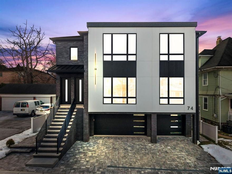 Welcome to a modern duplex in the heart of Palisades Park, featuring sleek design and quality finishes throughout. Each unit offers 3 bedrooms and 2.5 bathrooms, with bright living spaces highlighted by oversized picture windows that bring in abundant natural light. The kitchens include modern cabinetry, high-end appliances, and a built-in wine fridge, while the living rooms feature a stylish electric fireplace. The lower unit includes a finished basement with a flex room or office, half bath, attached two-car garage, separate side entrance, and backyard access. The upper unit offers a single-car detached garage. Both units feature private balconies. Conveniently located near downtown shopping and NYC transportation, this property is ideal for owner-occupants or investors seeking modern living and strong value.