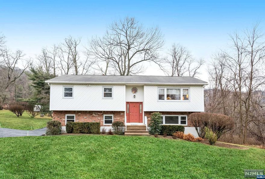 Feel the warmth as soon as you enter through the door! This 4 bedroom, 2.5 bath bi-level has been impeccably maintained throughout the years. Once inside, you will appreciate the beautiful hardwood floors throughout, the large living room and dining room, updated bathrooms, and the spacious eat in kitchen. Look out onto the beautifully landscaped, private yard while preparing a meal, or while sitting out on the expansive deck off the kitchen and dining room. Enjoy relaxing or spending time entertaining in the inviting family room on the first floor. This same level also contains a large and super bright 4th bedroom that would also make a great home office. Additionally, there is a half bath, laundry and access to the 2-car garage completing this level. Sitting pretty on almost .7 acres, this home is close to all that you need. Award winning Clarkstown Schools! Truly a wonderful home!