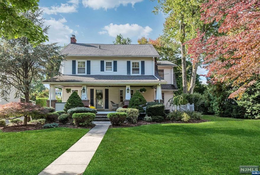 Welcome home to this beautiful 4+ bedroom colonial with the perfect mix of classic charm and modern finishes. The covered front porch enters into a front to back living room with fireplace & custom millwork. Archway to the banquet sized dining room, perfect for gatherings. Custom eat-in kitchen with cherry cabinets & high end appliances. Large dining area with French doors to the rear: an absolute entertainer's delight. Open floorplan to the family room, full of natural light. Convenient walk-in pantry & powder room complete this floor. Dual staircase to the second floor where you will find 4 generous bedrooms including an elegant primary suite with vaulted ceilings, bath and closets galore. Large hall bath. Walk-up third floor, perfect for an office, playroom or 5th bedroom. Unfinished lower level with laundry & endless possibility. Fully fenced yard with privacy plantings, 2 car garage & so much more. Great location close to dining, shopping & NYC transportation.