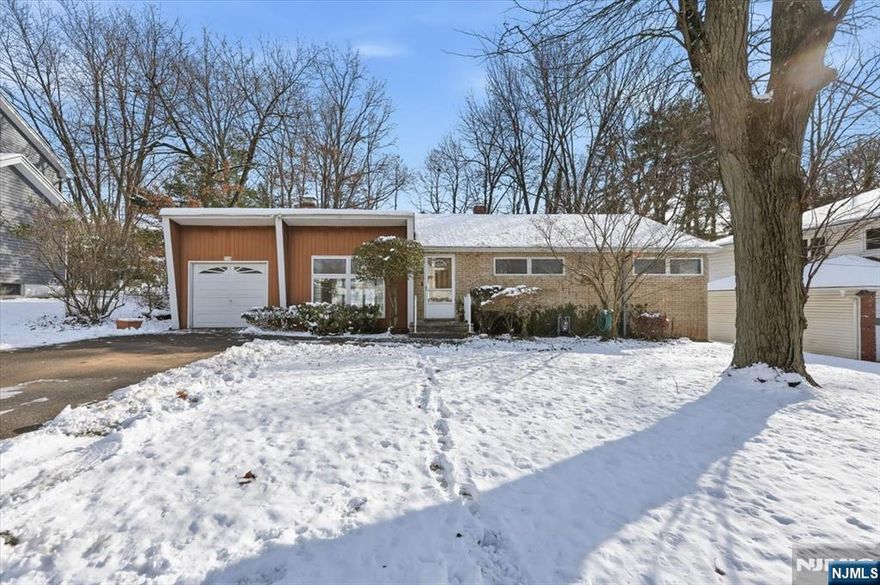 Welcome to this spacious 1778 sq ft and inviting ranch-style home in the desirable town of River Edge. This beautifully laid-out residence offers 4 generous bedrooms and 3 full bathrooms, including a private primary en-suite featuring a walk-in closet and its own entrance to a secluded backyard oasis. Enjoy indoor-outdoor living with a large deck, perfect for entertaining or relaxing in privacy. The open-concept kitchen flows seamlessly into the main living areas, highlighted by floor-to-ceiling windows that fill the home with natural light. Hardwood floors and a cozy fireplace add warmth and character throughout. Conveniently located close to top-rated schools, train stations, shopping, dining, and major commuting routes, this home combines comfort, space, and prime location. A wonderful opportunity to enjoy suburban living at its best. OFFERS ARE DUE on TUESDAY 12/23 by 4pm