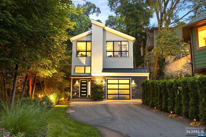 Nestled in the woods of the 'Palisades' along a babbling brook lies â€œThe Magic Garden' House", a hidden gem in The Edgewater Colony, a nature lovers delight. This South facing home lies on a bucolic 200"Ft deep wooded property set back 90" feet offering total privacy and the ambient sounds of water. Plus parking for over 6 cars. New home completed in Dec. 2018' w/tasteful architecture that is a perfect combination of nature & elegance. Large windows throughout with 9" ft ceilings on the main level. The walk-out full basement has lots of storage plus ample room for a wine cellar. Great flow for entertaining, with gourmet kitchen and large 5 x 9 ft island w/cooktop and hood leading to a large Trex deck and patio. The home also includes a bonus office, pantry, double oven, modern SS appliances, designer chandeliers, built in surround sound system, 72" FPL, generator, 1 car garage w/extra storage space, in ground sprinkler system, "seasonal" NYC views and more. Come and explore.