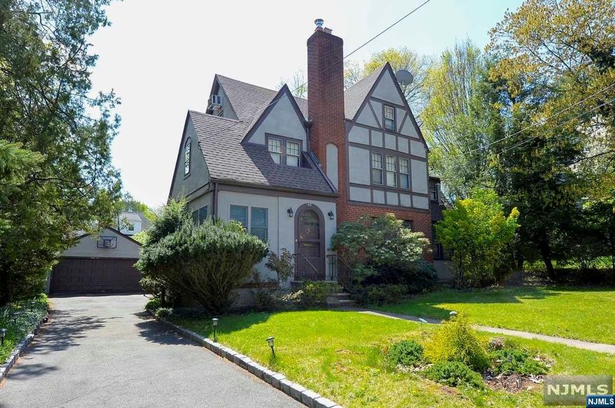 Renovated Colonial Tudor on desirable Tenafly street! Spacious floor plan with hardwood flooring throughout entire house! Renovated kitchens, baths and gas heating system! New roof! Lots of storage space. Private yard with a deck. Separate two car garage. Very close to school and bus!