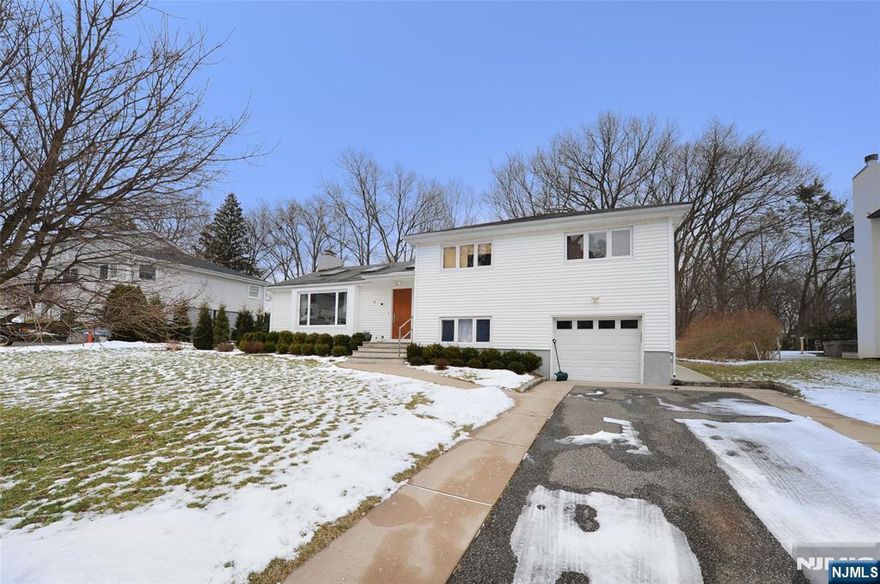 Welcome to this inviting split-level home for rent in desirable Fair Lawn. The main level welcomes you into a sunlit living room featuring an easy, open layout enhanced by designer touches, including a skylight, rich hardwood flooring, and a striking stone-surround fireplace that creates a warm focal point. The open-concept flow continues into the dining area and eat-in kitchen, complete with a breakfast bar, perfect for casual meals or entertaining. The dining room opens directly to a patio overlooking the backyard, offering a seamless indoor-outdoor connection. Upstairs, the home offers two generously sized bedrooms, a modern full bathroom, and a spacious primary suite with its own en-suite bath. The ground level adds valuable living space with a versatile family or recreation room, half bathroom, and convenient access to the one-car garage. The finished basement extends the homeâ€™s flexibility even further, featuring a full bath, a den or home office, and an additional family room, ideal for remote work, hobbies, or guests. Thoughtfully designed across multiple levels, this home offers abundant storage throughout, including a clean, easily accessible attic, ensuring everything has its place. Filled with natural light and offering a welcoming layout, the home is ideally located near top-rated schools, shopping, dining, parks, and transportation, an exceptional opportunity to enjoy comfort and convenience in a place youâ€™ll be proud to call home.
