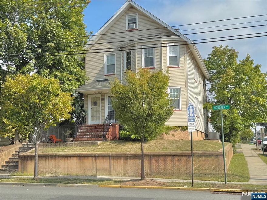 This well-maintained 2-family house sits on a sunny corner lot and offers approximately 2,479 sq ft of living space per tax records, with four bedrooms plus a large finished attic bonus room. The first floor features a private entrance with a foyer, a spacious living and dining room with hardwood floors, and a large kitchen with plenty of cabinet space. Two good-sized bedrooms with ample closet space complete the layout. The second floor mirrors the first, with the same comfortable layout of living and dining room, kitchen, and two bedrooms, plus access to a finished attic with a large bonus roomâ€”ideal for a home office, playroom, hobby space, or additional storage. Filled with natural light throughout the day, the home is bright and welcoming. The property also includes a large unfinished basement with a convenient side entrance, laundry hookups for each unit, and generous storage space. Utilities are separate for each unit, except water. Central A/C provides comfort throughout the home. No driveway, however, plenty of street parking is available with a permit. The house offers a Manhattan view and is conveniently located close to NYC bus and train transportation, downtown, and local parks.