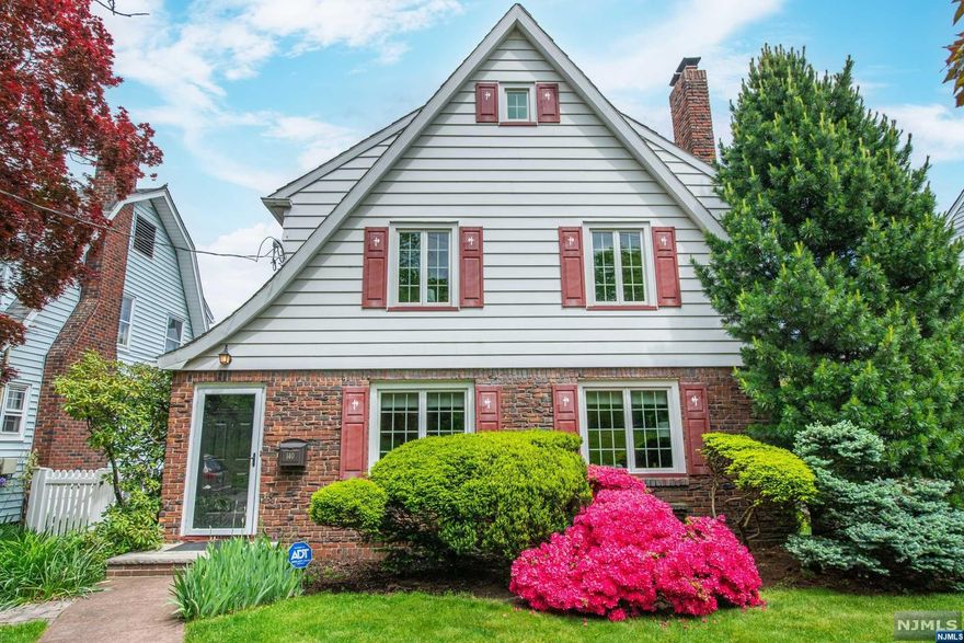 Nestled across from Brookdale Pk, this charming home invites you to experience cozy living. Picture-perfect sunsets over the park create a serene backdrop. Inside, original woodwork and crown molding add character, while 2 fireplaces beckon you to unwind. The spacious rear patio, cedar closets, and finished basement enhance the appeal. As you explore, you'll discover a lovely large balcony off the primary bedroom a perfect spot for morning coffee or stargazing. Central A/C ensures comfort year-round, and the driveway accommodates two cars for convenience. The landscaped rear yard, adorned with mature flowers, leads to a spacious stone patio ideal for alfresco dining. And don't miss the well-appointed eat-in kitchen, where aspiring chefs can whip up culinary delights. Conveniently located, this home offers easy access to NY transit, nearby amenities & highly rated schools. Whether you're commuting to the city or enjoying local shopping & dining, this neighborhood has it all!