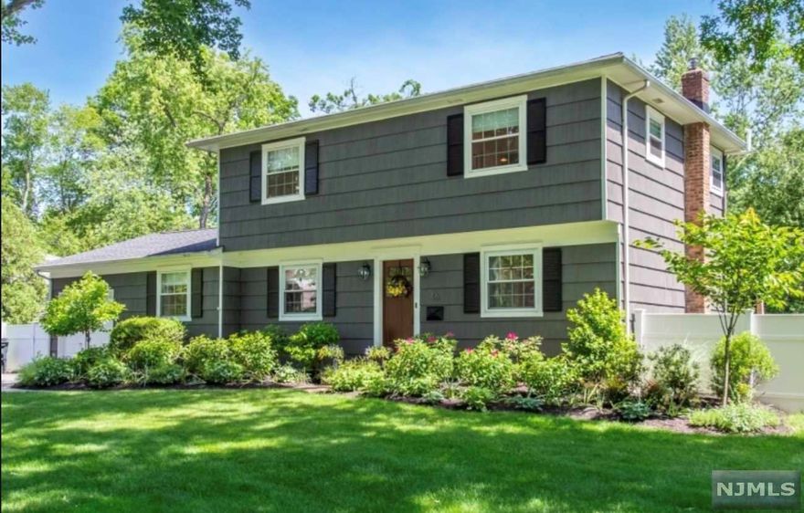 Basking in natural light, this whimsical and charming center hall colonial is perfectly located on a classic Berkeley Heights street! An inviting entry welcomes you into this colorful home that pops with light and space. Classic feel highlights the large living and dining room with original wainscoting and detail. The family room off of the kitchen makes a perfect flex space for a playroom, media room or to entertain with a walk out to the yard. The eat-in kitchen has ample storage and work space for today's cook with excellent flow for entertaining. The amazing outdoor space allows for plenty of extra living, relaxation and overlooks the deep and perfectly level and serene backyard with mature landscaping, gardens and privacy fence. 2nd fl: three spacious bedrooms include oversized primary with walk- in closet. Basement offers loads of potential with laundry, storage and recreation room. Bonus space is the garage with added heat and custom shelving system! Many Upgrades!