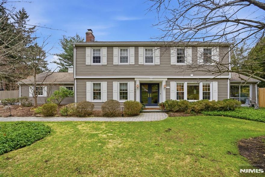 Beautifully updated and meticulously maintained expanded Colonial located on desirable East Hill Street, just minutes from NYC transportation and top-rated schools. Set on a lush, landscaped property with a stunning 20x40 heated in-ground pool and patio, perfect for entertaining and relaxing. The main level offers a welcoming entry foyer, spacious living room, family room with gas fireplace, large sun-filled dining room with access to the yard, fully updated eat-in kitchen with high-end appliances, powder room, laundry room, and charming three-season porch overlooking the backyard. The second floor features a spacious primary suite with renovated bathroom, four additional bedrooms, and an updated hall bath. Additional features include hardwood floors, crown moldings, skylights, Bose sound system, two-car garage with extra attic storage, and updated mechanicals including roof, furnace, and central air. Move-in ready in a prime Tenafly location near parks, shopping, and houses of worship.