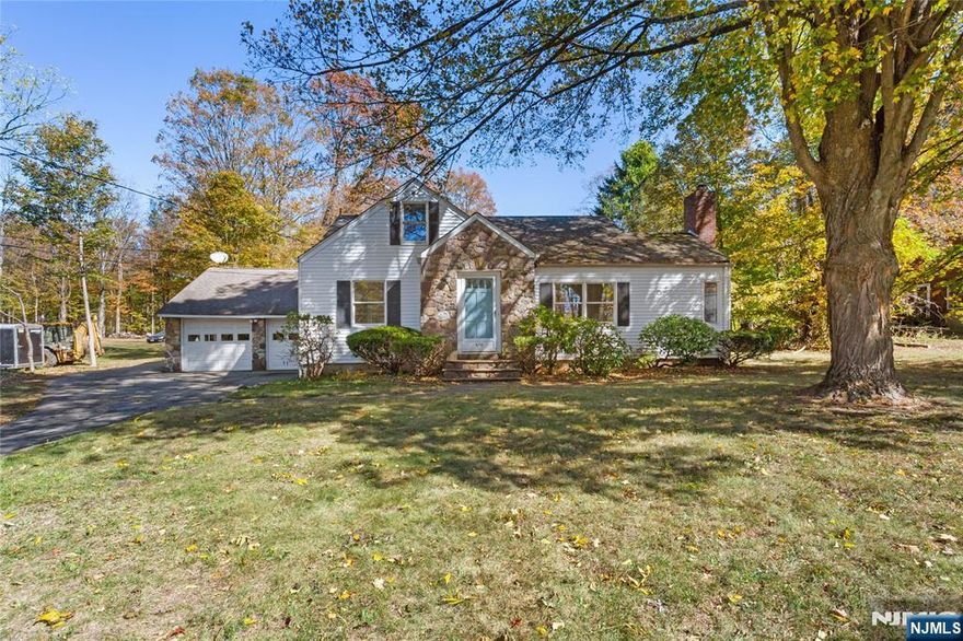 Charming Ranch in the Heart of West Milford! Welcome to 870 Macopin Road, a spacious 3-bedroom, 2-bath ranch offering classic charm, generous living space, and a peaceful setting surrounded by nature. This home sits on a large, level lot lined with mature trees, providing both privacy and a beautiful backdrop for outdoor living.Step inside to discover an open and airy layout with sun-filled rooms, arched doorways, and hardwood flooring. The living room features a striking stone fireplace, perfect for cozy evenings, while the family room showcases a brick accent wall and large picture windows that bring in natural light and views of the outdoors. The kitchen features warm wood cabinetry, brick details, and skylights for added brightness perfect for your personal touch or full customization.Enjoy the spacious yard ideal for entertaining, gardening, or simply relaxing under the shade of mature trees. A two-car garage, ample driveway parking, and a desirable West Milford location close to schools, parks, and commuter routes complete this inviting home.