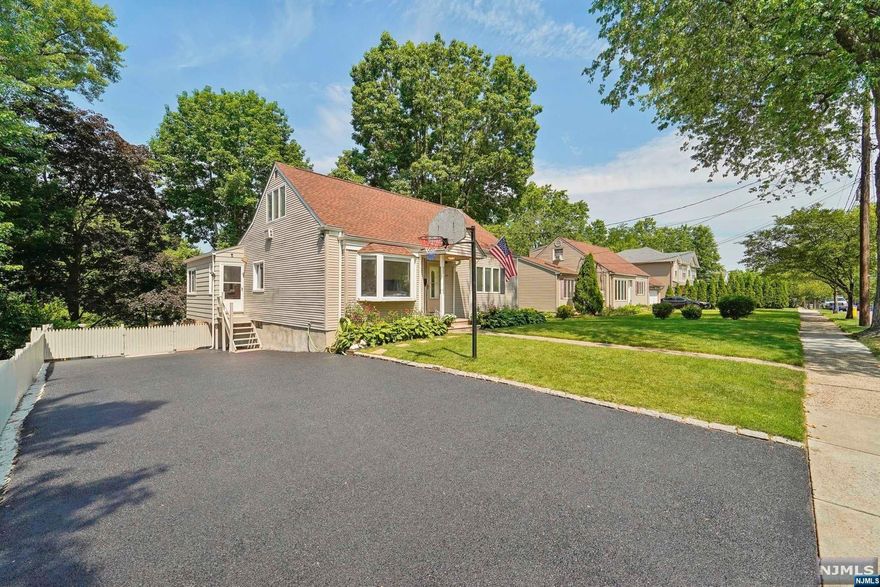 SPACE & GRACE are yours in this 4-5 Bedroom, 3 Bath Renovated Home! High Ceilings, Open Floor Plan, Pool, Gleaming Hardwood Floors, Cent Air, Sundrenched Deck, Walk-Out Lower Level - everyone who visits is uplifted by this light, bright space. Large Professionally Landscaped Property on Desirable Street. Fully Fenced Yard, Inground Sprinklers, Newly Paved Doublewide 6-car Driveway...Won't Last! Call For Private Showing.