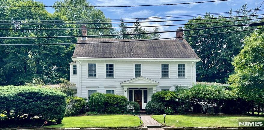 Nestled in the Old Smith section of Tenafly, NJ, this timeless prewar center hall colonial blends classic charm with modern updates. The home features a gracious layout with a large living room, dining room, and family roomâ€”each with its own fireplace. A sun-filled bonus room off the living room adds flexibility, while the expanded family room includes a wet bar, half bath, and French doors leading to a bluestone patio and spacious yardâ€”perfect for entertaining. The updated kitchen with dining area flows easily from the family room, forming the heart of the home. Upstairs offers two bedrooms plus a generous primary suite with fireplace and private bath, and the third floor includes three more bedrooms and a full bath. The finished basement adds a bath and sauna for extra comfort. Set on a large lot near top-rated schools, parks, and commuter lines, this home offers elegance, space, and convenience in a prime Tenafly location.