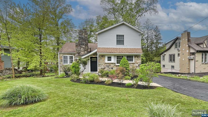 This captivating Colonial Cape in Packanack Lake exudes charm and character, boasting a recent renovation that adds modern flair to its classic appeal. Featuring 3 bedrooms and 2.1 sleek, contemporary baths, it welcomes you into a great room adorned with a vaulted, beamed ceiling and a striking stone fireplace. A sizable dining room, offering access to a generous deck that overlooks the serene surroundings. Adjacent, a pristine white kitchen adorned with quartz counters and a subway tile backsplash. Freshly painted walls and refinished hardwood floors enhance the home's allure. Descend to the expansive walk-out basement, where you'll find a convenient half-bath and laundry facilities, leading out to a backyard complete with a stone patio. Embrace the lake life experience with access to two beaches, a clubhouse, tennis and pickleball courts, swimming, fishing, and more. Don't miss the opportunity to make this meticulously crafted abode your own slice of paradise in Packanack Lake.