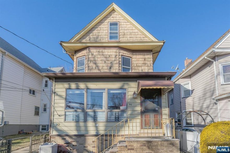 This unique mixed-use property combines residential and commercial functionality, offering exceptional versatility. The medical office is approximately 500 sq. ft. and features two examination rooms, an X-ray room, two offices, a waiting area, and a full basement for storage. The residential unit spans three floors and includes four bedrooms, a full bathroom, an eat-in kitchen, a living room, and first-floor laundry hook-ups. Both units are equipped with central air, separate gas and electric utilities, and a central vacuum system. Solar panels provide additional energy efficiency. The property also features two off-street parking spaces at the rear and easements in the side and rear yard. Perfectly located near amenities and transportation, this property offers an outstanding opportunity.