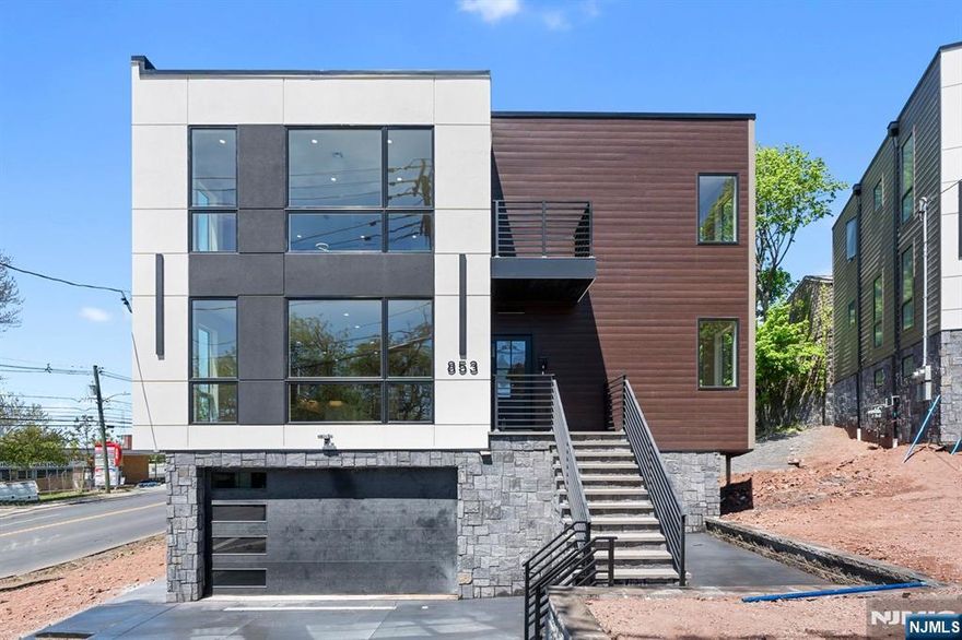 Welcome to Unit 1 of this stunning, brand-new two-family home, ideally located on a quiet residential street in Ridgefield, NJ. This expansive duplex spans the first floor and ground level, offering 3 spacious bedrooms, 4 full bathrooms, and a thoughtfully designed layout perfect for modern living. Step into an open-concept space filled with natural light from floor-to-ceiling windows, creating a bright, airy ambiance. The designer kitchen is a showstopper, featuring custom cabinetry, premium appliances, and a striking stone waterfall islandâ€”ideal for both everyday dining and effortless entertaining. The main level features a sunlit living and dining area, an ensuite bedroom, a second bedroom, and an additional full bath. The ground level offers a flexible recreation room, laundry area, and a private primary suite with a spa-inspired bathroom and ample closet space. Direct access to the garage and additional storage adds to the homeâ€™s functionality. Enjoy 1 garage parking space and 1 driveway space included with the unit. Tenant is responsible for all utilities. Conveniently located near major highways, public transit, parks, and shopping, this home is the perfect blend of luxury, space, and prime location in Bergen County.