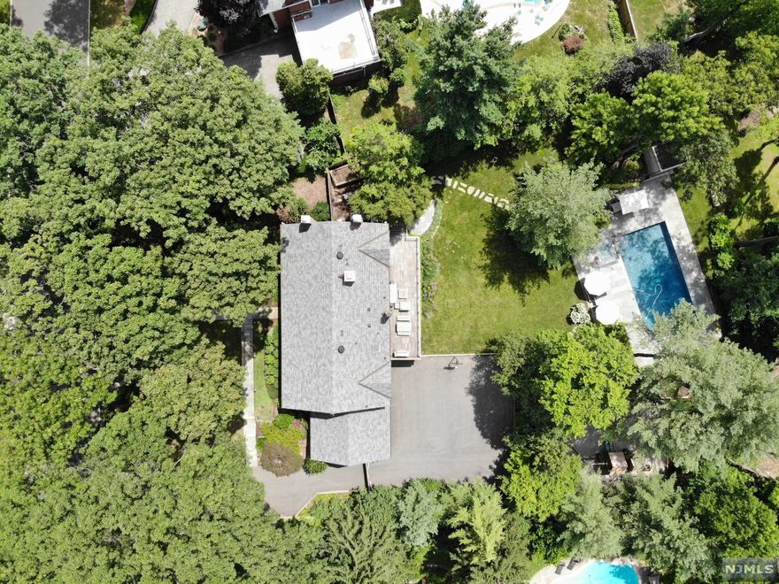 Welcome to this magnificent masterpiece on stunning property located on one of the most sought after streets on the east hill of Englewood. From the welcoming entryway to backyard oasis with salt water pool and deck, bluestone patio, kid's playground in a park-like setting, this home is a must see! Gorgeous Owner's suite w/FP, 4 other bedrooms including 1 on 1st floor, 5.5bths. All motorized window treatments, state of the art custom kitchen including Viking stove and ovens, center island with Caesarstone countertops. An elegant library and fantastic kid's playroom and den make this a very special place. Home features large rooms for formal entertaining and casual family gatherings. Newer roof, HVAC, electrical panels, garage doors, security gate, alarm system, 2 sump pumps, French drains and boiler. Brand new garage floor and added landscaping. Near Englewood shopping and restaurants, houses of worship, 10 min to GW bridge.