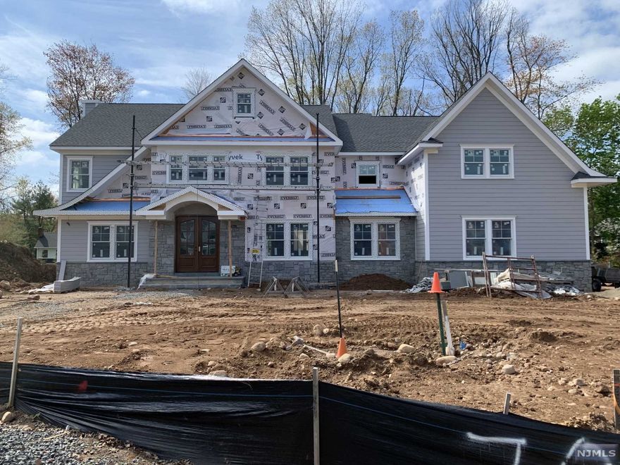 Stone & Hardi plank Hampton style home with 4770sf. Available early this fall.Still time for customizing. Homey feel with side porch entrance to mud area with built-in. The country kitchen with SUBZERO & WOLF appliances has a large island & dining nook open to backyard. Butler Pantry services kitchen and dining room. Kitchen flows into family Rm w/fpl, coffered clg and built ins. Custom trim and moldings throughout. Home office close to side entry Second floor includes Primary Suite w/trey clg, 2 WICs, and spacious bath with free standing tub and seperate vanities. Four additional BRS; two baths, lstairs to walk up attic, laundry complete upstairs Entertain in your backyard on your large bluestone raised patio with masonry see thru fpl features covered and open area Home must be seen, many special details. Landscaping w large # green giant trees/sprinkler, and sod. Full poured concrete basement with 9 foot ceiling. Great school system, community and location. Room for poo