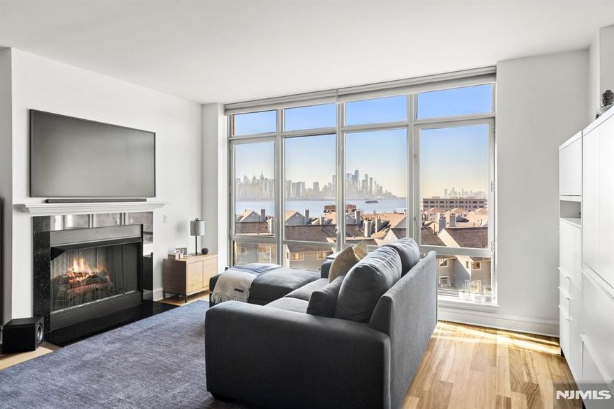 CONTACT MARK FOISEY JR (201) 582-8800 - THE WATERMARK, RESIDENCE 716 - A beautifully appointed 2-bedroom residence offering 1,472 SF of refined living space with southeast exposure capturing views of the Hudson River and the New York City skyline. The thoughtfully designed open kitchen features sleek stainless steel appliances and modern finishes that flow seamlessly into the spacious living and dining areas. The luxurious marble primary bathroom includes a large soaking tub and separate glass-enclosed shower, while the second bedroom offers a generous walk-in closet. Floor-to-ceiling windows fill the home with natural southern light throughout the day. Complete with in-unit laundry and two garage parking spaces. Residents enjoy full-service living with 24-hour concierge, indoor and outdoor pools, fitness center, and a private shuttle to the NY Waterway Ferry.