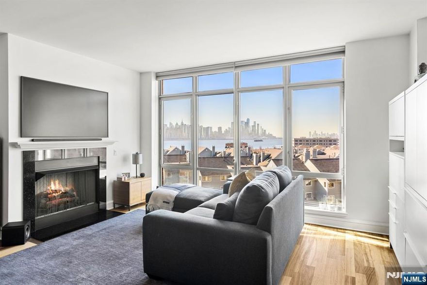 CONTACT MARK FOISEY JR (201) 582-8800 - THE WATERMARK, RESIDENCE 716 - A beautifully appointed 2-bedroom residence offering 1,472 SF of refined living space with southeast exposure capturing views of the Hudson River and the New York City skyline. The thoughtfully designed open kitchen features sleek stainless steel appliances and modern finishes that flow seamlessly into the spacious living and dining areas. The luxurious marble primary bathroom includes a large soaking tub and separate glass-enclosed shower, while the second bedroom offers a generous walk-in closet. Floor-to-ceiling windows fill the home with natural southern light throughout the day. Complete with in-unit laundry and two garage parking spaces. Residents enjoy full-service living with 24-hour concierge, indoor and outdoor pools, fitness center, and a private shuttle to the NY Waterway Ferry.