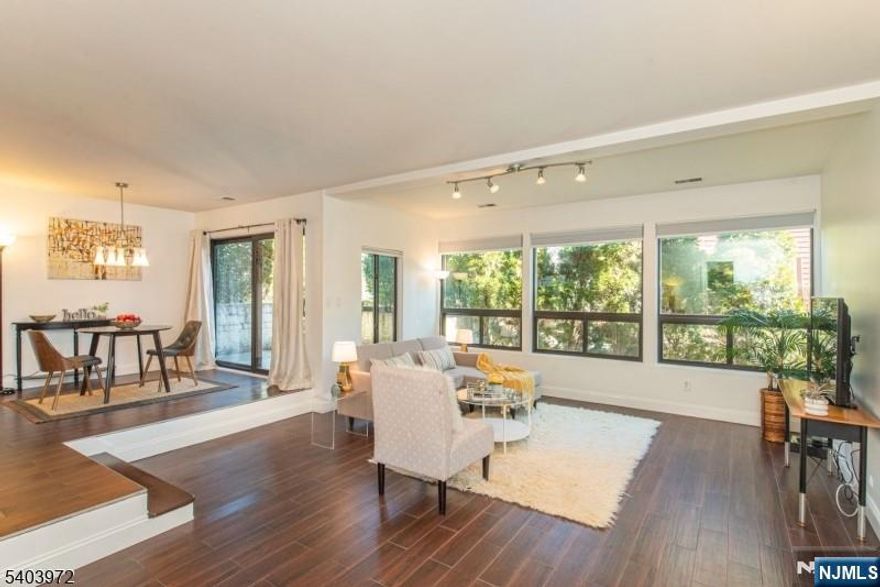 LOCATION IS KEY for this COMMUTER'S DELIGHT - steps from NYC BUS! Easy condo living near highway (Rts. 21 & 3), restaurants, parks, ShopRite & more. Sizable sunken living room, oversized bedroom w/ full wall of double closets, kitchen open to LR w/ plenty of wood cabinets & counter space, SS appliances & long breakfast bar, plus porcelain floor tiles for EZ maintenance & loads of storage. Highly functional layout in the bathroom w/ full tub. Dining area w/ large sliders to cozy patio. Updates include fresh paint (2025), stackable washer (2024) & dryer, new Pella windows & slider (2025), hot water heater (2022), & A/C + heat pump (2021). 1 assigned parking spot (#22) w/ plenty of visitor parking. Many generously sized windows w/ privacy landscaping, nest thermostat & additional assigned storage in basement. Whether it's your first home or you're downsizing, you will not be disappointed. This move-in ready home is more spacious than you think - come & take a look! This is the ONE!