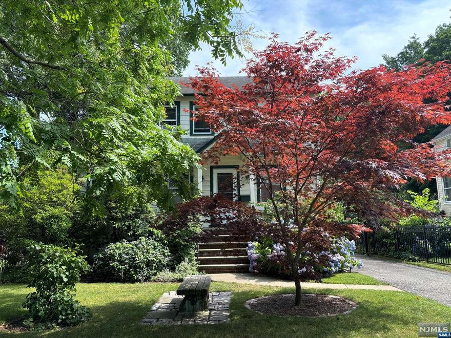 Great location close to NYC bus with lovely garden and gate with a wraparound porch for lazy days and relaxation. Living with fireplace , office or playroom and dining room, powder room, kitchen with D/W. 3 bedrooms with porch off the master bedroom. Attic for storage or 4th bedroom. Unfinished basement, with new hot water heater, chimney liner, newer W/D and brand new freezer included and gas heat. Fully fenced backyard for added privacy.