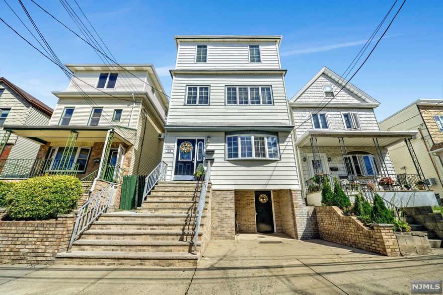 Commuter's Dream Home! Schedule showing now!ONLY 1 Block from LIGHT RAIL!1/2 mi from TURNPIKE!Plans proposed for Ferry Service Bayonne - Manhattan. This beautifully-maint 2-fam home is set to be sold!Poss of a 3-fam subject to approval from municipality.The 1st fl unit is a completely renovated apt.Well lit & boasts BEAUTIFUL HW Flrs, tons of storage, bathroom,modern EIK w/ new SS appliances & laundry hook.The 2nd-flr unit is HUGE!Enter into formal dining room,enjoy the LR complete with a beautiful wood burning fireplace,custom built-in shelves,full bathroom.Large dining room leads to the sprawling EIK that centers around a large island.EIK has an oversized pantry. Take the staircase up to find a bonus sitting room,3 large bedrooms and skylights in the TV room, a 2nd full-bathroom, and a full laundry room.The back bedroom has a spacious balcony which overlooks the huge backyard. NEWLY renovated bottom level can be converted into a 3rd unit/used as extended family.