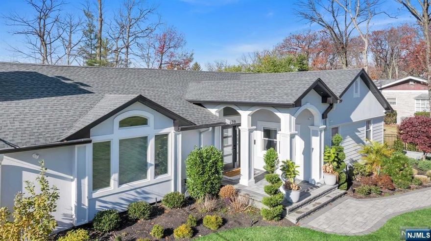 Step into this newly remodeled contemporary home with stunning Western views and a light-filled, open layout. At its heart is a sleek white chef's kitchen featuring Italian custom cabinets, Wolf ovens, and a quartz center island. The living room, with its cathedral ceiling and modern fireplace, flows seamlessly into the dining room, which opens to a deck overlooking a beautifully landscaped private backyard with a resort-style pool and an amazing outdoor kitchen. The primary suite includes a luxurious bath, and French doors to the deck. Two additional spacious bedrooms and a stylish new bathroom complete the main level. The ground floor boasts a large recreation room, an office, guest bedroom with a full bath, laundry room, mudroom, and oversized two-car garage. Nestled on Englewood's East Hill, this pristine, high-design home on close to half an acre is move-in ready. Located just 6 miles from NYC and close to transportation, houses of worship, and shopping.