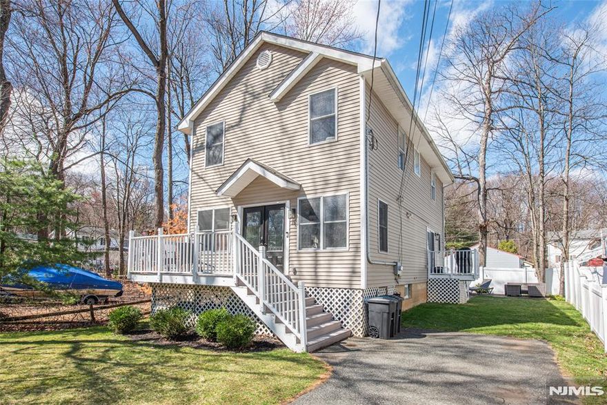 Located in the highly desirable Indian Lake community, this beautifully fully renovated 3-bedroom, 2-bath Colonial offers comfort, style, and a peaceful setting on a quiet dead-end street with minimal traffic. Inside, you'll find a bright and inviting layout filled with natural light throughout. The updated kitchen features granite countertops, stainless steel appliances, and modern finishes, making it both functional and stylish for everyday living and entertaining. Just off the kitchen, a door leads to a fenced-in backyard complete with a patio and storage shed, perfect for outdoor gatherings, pets, or relaxing evenings. The cozy living room is highlighted by a wood-burning fireplace, creating a warm and welcoming space during colder months. Upstairs, the primary bedroom boasts vaulted ceilings and skylights, adding an open and airy feel with plenty of natural light. The home boasts ample storage with options of the shed, attic, basement and crawl space. Enjoy the benefits of being very close to the water, two public docks, three beaches, two playgrounds and the clubhouse where there are many fun events! With its modern updates, charming character, and prime Indian Lake location, this home offers the perfect balance of privacy, comfort, and convenience.