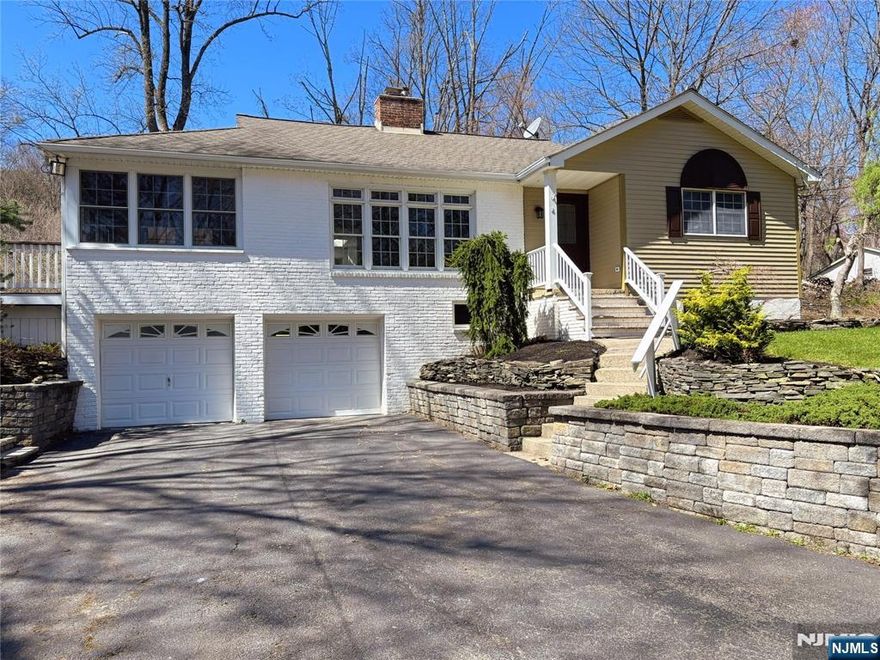 Welcome to this beautifully updated 3-bed, 2-bath ranch on a private dead-end road, set on a stunning one-acre naturally landscaped lot just one hour from NYC. Featuring over 2,300 sqft of finished space, step inside to abundant natural light and refinished hardwood floors throughout. The showstopping kitchen boasts new luxury two-tone slim shaker cabinetry, skylight windows, quartz countertops & backsplash, and stainless steel appliances. The dining room impresses with soaring 12 feet vaulted ceilings and walls of windows. French doors open to a gorgeous year-round sunroom flowing onto a massive wraparound deck, perfect for entertaining. Cozy up by the wood-burning fireplace in the spacious living room. The primary suite offers generous closet space and a private full bath. The finished ground floor features an expansive open recreation room ideal for entertaining, a home gym, or multigenerational living, plus a dedicated laundry room. Car enthusiasts will love the oversized 2-car garage, an impressive 30 feet deep with a workshop room! A walk-up attic adds even more storage and expansion potential. Central A/C & baseboard heating. A natural creek winds through the private backyard, a peaceful retreat year-round. Space, privacy, and modern comfort. Don't miss your chance!
