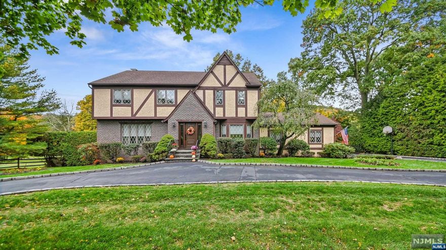 Welcome to a one-of-a-kind opportunity to own this lovely 4BR/3.5BA Colonial with simply breathtaking views and a superior location. A circular drive takes you to the entrance of this Tudor style home with a traditional layout; entry foyer, light and bright liv rm w/gas frplc, formal din rm, eat in kit w/sep bkfst area and beautiful views of the bucolic yard. Fam Rm has woodburning brick frplc and sliders to deck. Mudroom w/laundry, updated half bath and entr to 2 car gar complete 1st level. 2nd level has 4 spacious bedrooms which includes a lovely master suite w/updated full bath, walk in closet,and a Juliette balcony for stunning views of the property. Basement is finished with ofc/gym,full bath,rec room,kitchen and door to rear patio and the heated,inground pool! Separate play area w/swings, fenced in lawn area and fire pit to enjoy those special evenings under the stars! This home has been lovingly maintained, incl. new HVAC! A very special place to call HOME!