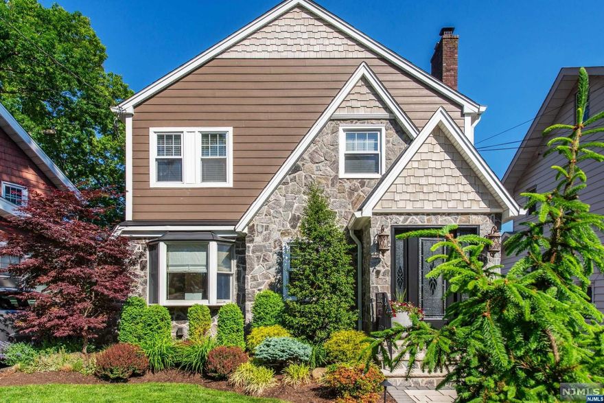 This immaculate and charming home is situated in a desirable and premiere location offering 4 bedrooms, 1 1/2 bathrooms, outdoor pool w/privacy fencing, stone patio, luscious landscaping and updates throughout while nestled on a quiet tree lined one way street. First level offers an entrance vestibule, formal living room w/gas fireplace open to the dining room and updated kitchen w/island, beautiful SS appliances and granite counters / tile backsplash, door leading to the yard, pantry, bedroom w/new powder room and beaming hardwood floors. Primary bedroom, two additional spacious bedrooms, large walk-in closet and updated bathroom w/stall completes the second level. Attic is walk-up and full in size, can be easily finished into more space if needed. Basement is freshly painted with plenty of storage, can be used as a spacious den/rec room. Updates: Hardy Plank siding, new roof, new walkway, driveway, patio and beautiful pool! Close to transportation and shopping. Welcome Home...