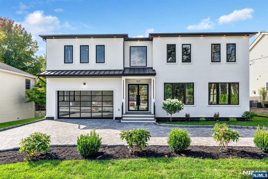 Spectacular brand new construction colonial in ultra-desirable Paramus. Gorgeous finishes top to bottom. Great floor plan with 6 bedrooms & 6.5 bathrooms. Main level offers LR, DR, Gourmet Kitchen w gorgeous cabinetry & huge center island and a double height Great Room. Additionally featuring a RARE TO FIND 1st level that offers both a home office & guest bedroom suite with a full bath. Office offers glass doors. 2nd level boasts massive primary suite w. custom WIC & spa-like bathroom with tub, huge shower, double vanity, & SAUNA! 3 additional bedrooms each feature en-suite baths. Fully finished basement with large rec room & 6th bedroom suite. 2 car garage, U shaped driveway for additional parking, and beautiful backyard with covered patio. Stunning interior design features such as lux. tile, wood trim accent walls, black railings, lit shower niche's & more. Paramus is home to amazing schools, great shopping & easy access to NY. You will be thoroughly impressed by this stunning home.