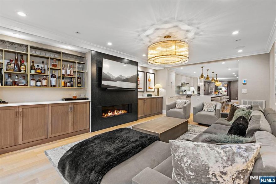 Welcome to 1237 Garden Street, a stunning single-family brownstone located in the heart of Hoboken. This impeccably renovated home, completed in 2020 by a prominent local builder, offers 3,212 sqft of luxurious living space, seamlessly blending historic charm with modern sophistication. Step inside to discover a thoughtfully reimagined interior featuring 4 beds, 5 baths, and a host of premium upgrades. The open floor plan is adorned with custom white oak floors, walnut cabinetry, and quartz countertops. The chef's kitchen boasts high-end appliances, a large island, and a leathered granite outdoor kitchen. Smart home technology includes integrated speakers, Ring doorbells, and pre-wiring for security. Modern comforts feature a Navien boiler, 3-zone radiant heat, and advanced HVAC. The serene backyard offers synthetic turf, irrigation, and a tiled patio. Every detail was carefully curated to deliver style, comfort, and convenience-making it an extraordinary place to live in Hoboken.