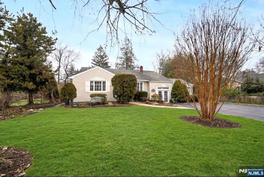 Located on a desirable corner lot just shy of a private one-half acre, this well-maintained 3 bedroom, 2.5 bath split-level home offers flexible four level living and work-from-home space. Upper Level: Three bedrooms including a primary bedroom with full bath, plus an additional full bathroom. Main Level: Open floor plan with kitchen, dining area and living room featuring a vaulted ceiling, creating a bright flow for everyday living and entertaining. Ground Level: Private French door entry opens to a home office space, ideal for meeting clients or working from home, leading to a private office/den and a spacious 14 x 32 family room with sliding doors to a large deck overlooking the expansive private rear garden and small greenhouse. Powder room and two closets also located on this level. Lower Level: Semi-finished work room and laundry area plus a large food-grade refrigerator for additional storage. Attached one-car garage and driveway parking.