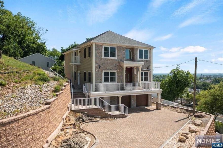 This remarkable 2019 built home boasts an incredibly spacious layout and versatile design, reminiscent of a 2-family dwelling with 3710sqft of living space. Each floor is a mirror image to each other offering 2 kitchens, 2 living rooms, 2 dining rooms, 2 primary bedroom suites, 2 laundry rooms and a total of 6 bedrooms. Separate entrances for privacy and self contained living spaces. Its the perfect multi-generational home sitting on a gorgeous hill. Two attached car garage with an unfinished basement and endless possibilities. Outside, the property offers a side yard and back patio, ideal for outdoor gatherings, gardening, or simply unwinding. Home is located on the boarder of Totowa and Wayne, near parks, schools, shopping and public transportation, minutes away from NYC.