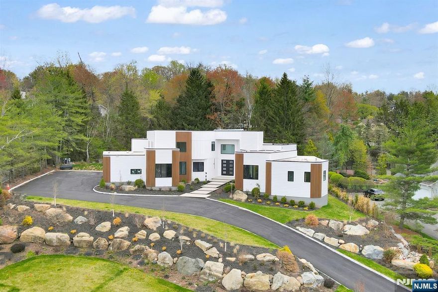 Newly constructed, 9BD, 8.1 BA contemporary home in the prestigious Chestnut Hill neighborhood offering approximately 13,000 sft of exquisitely crafted living space across 3 levels set on nearly AN ACRE of beautifully landscaped resort style private grounds w/ a sparkling POOL. Grand 2 story foyer illuminated by a skylight, leading to a spacious FR w/ SOARING 20 FT CEILINGS. Elegant formal living & DR open seamlessly to an expansive covered deck. The designer kitchen is outfitted w/ top-of-the-line WOLF & SUBZERO appliances, designer cabinetry, waterfall island, butlerâ€™s pantry, & a large walk-in pantry. The primary suite is a true retreat, featuring a spa-inspired BA, dual designer walk-in closets, an attached yoga and meditation space w/ skylights & a private office. Highlights include a dramatic statement staircase, custom built ins throughout, 4car garage & a fully finished massive basement w/ 9ft ceilings. This smart home is equipped w/ Ring, Nest thermostats & EV charger outlets.