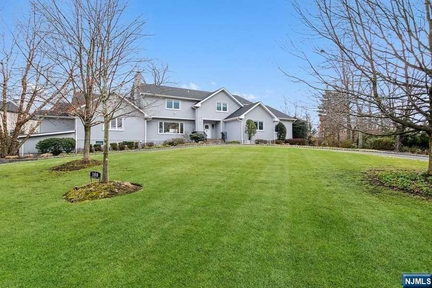 Set on an acre on one of Tenafly's most prestigious streets,188 Buckingham is the brightest prettiest home. Boasting an open plan concept, the expansive first floor is inviting and impressive thanks to raised ceilings and the many windows overlooking the stunning backyard and tennis court. The newly renovated kitchen looks out to the family room with easy access to the dining room and formal living room making entertaining here a pleasure. An additional huge room which could double as a studio, or playroom is a bonus. Completing the first floor are 2 offices, 2 full bedrooms with ensuite bathrooms, 2 further powder rooms and a laundry room. Upstairs you will find a luxurious primary suite featuring 2 walk in closets and spacious bath. Perfecting the second floor are 2 more bedrooms sharing a Jack and Jill bathroom and a mini suite. Don't miss out on this unique beauty!