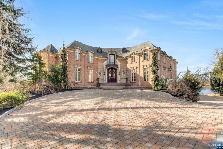 This architectural triumph combines classic opulence and the modern feel of today with its exquisite features and luxurious quality finishes.An unrivaled French Chateau envisioned and executed by renowned Commorata-Berardi Builders. The Chateau set upon a picturesque 2.25-acre water front parcel and only moments from Indian Trail Club. Enter through wrout-iron gates into peaceful courtyard that showcases the extraordinary scale of the home. With over 9,500 sqft,a voluminous atmosphere awaits,with a dramatic foyer, grand-scale rooms and an abundance of natural light.A soaring two-story great room with two fireplaces,and French windows welcome you!Grand sized kitchen, banquet sized dining rm,intimate living room w/FP and wet bar,and Cherry library are among some of the lush living spaces.The grand primary bedroom quarters is comprised of a light-filled bedroom with balcony overlooking the lake, his/her closets,sitting rm,and an unparalleled bathroom. 4 en-suites. Must see this home