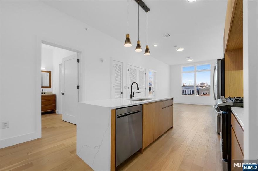 Introducing Tailor House at 38 Union City - PENTHOUSE UNIT Hudson County's newest luxury condominium building. With just 48 residences, this boutique elevator building offers privacy, style, and convenience, only 15 min from NYC by bus. Tailor House at 38 redefines modern living with oversized 1 & 2 bedroom homes featuring open layouts, soaring 9-10 ft ceilings, & spacious bedrooms. Kitchens are equipped with waterfall quartz countertops, sleek islands in select units, European style two-tone oak cabinetry & GE Professional Series appliances. Bathrooms offer floor-to-ceiling porcelain tiles, glass-enclosed showers, and marble-top vanities, creating a spa-like atmosphere. Amenities include a fitness center, luxury lobby, garden terrace, & smart security with Swiftlane intercoms. Assigned parking is included, with extra spaces available for purchase. Plus, enjoy the added benefit of a 5-year tax abatement. Discover a lifestyle of convenience nestled in the heart of historic Union City.