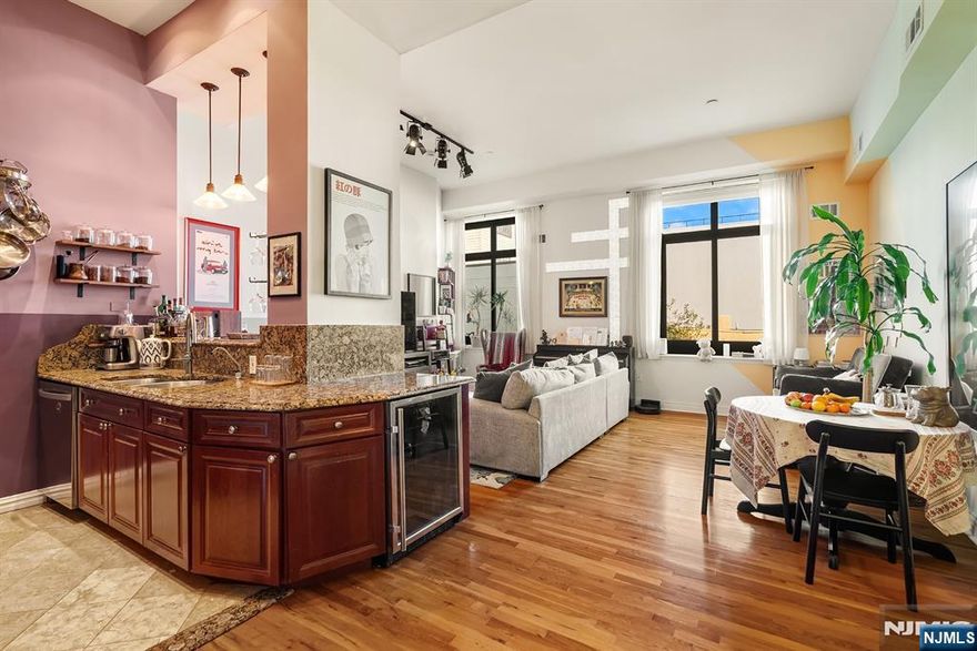 Loft Bliss-Contact Angela Cuciniello 201. 657-6084 for details. One of Kind inspiring Soho Loft style meets a slice of the Iconic NYC skyline in this 2 Bedroom 2 Bath condo. Surrounded by urban convenience in Prime Weehawken. A picturesque bluff-top location that delivers elevated tranquility is your haven. Alluring loft style design is loaded w/ distinctive architectural details from soaring 14+-foot ceilings to walls of oversized newer windows;(2020 energy efficient). The ideal open concept layout showcases partial views of NYC Midtown Skyline from all rooms. A generous sized Living, Dining & suburban size Kitchen embrace the way we like to live now w/ a warm vibe. The Chef's Kitchen is sure to please w/ abundant cabinetry, granite counters, SS appliances; new DW; gas vented cooking range & plenty of prep counter space. A dining peninsula w/ wine fridge & dangling pendant lighting is ideal for guests to gather. Down the hallway find 2 spacious bedrooms, 1 modern tiled full bath. Tranquility awaits in the Primary Bedroom boasting a dressing area, walk-in-closet & luxury tiled full bath. Notable: Central HVAC; New W/D, Pet friendly. HOA Inc:1 garage pkg; h/c water, Amenities: 24hr concierge. Discover Gregory Commons gated luxury condo. Exciting new hallways renovations are in progress! Amenities: Fitness; Indoor Pool; Sauna; Lounge; Courtyard. A Commuter's Paradise-only 2-Miles to NYC PA via NJ transit Bus, NY Waterway Ferry or car. Just 2 blocks away. Don't Miss out!