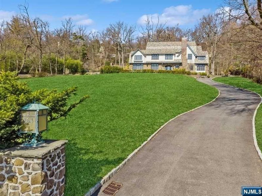 This luxurious and spacious estate sits on over an acre of lush property with stunning year round skyline views and over 7000 sq. ft of living space. Coffered ceilings and fireplaces add elegance to the living, dining, sunroom, and family rooms. The chef's kitchen features a LA Cornue 6 burner range, SubZero refrigerator, custom cherry cabinetry, walk-in pantry and leather marbleized island. The primary suite includes his and her sitting rooms, walk-in closets, and spa like bath with an oversized soaking tub and shower with a rain shower head, and separate toilet commode room. The finished basement has a media room and full bath. The HVAC system includes radiant heat, forced air boiler (2020), and central air with 3-zones. 3-car garage, extensive landscaping, blue stone patio, and underground sprinkler system complete this luxurious property. Simply unpack your bags and move in! Property assessment 2024 tax book is $1,785,900. Block 602 lot 13.01