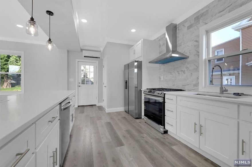 The entire house, including the basement, has undergone a comprehensive renovation. Upgrades encompass new windows, electrical, plumbing, and Mechanical systems. An engineer reimagined the space, creating an open-concept floor plan on the first level with a convenient half bath. The kitchen boasts Samsung appliances and a sleek quartz countertop. On the second floor, discover four bedrooms complemented by an opulent bathroom. Ascend to the third floor to find a master bedroom alongside a lavish double shower Master Suite Bathroom. Mini split AC units are strategically placed for personalized climate control throughout the residence, managing both cooling and heating. Outside, the lawn has been regraded and replenished with fresh grass, complemented by a brand-new front porch. Completing the picture is a new driveway with space for up to four cars. Text listing agent for confirmed appointment . ******** Please don't use showing time.*********