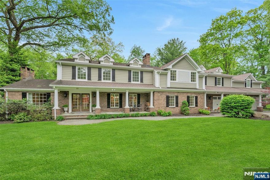 Located on a peaceful cul-de-sac, this stately 5-bedroom Colonial with blue stone porch offers timeless elegance with today's modern conveniences. At the heart of the home is a beautifully designed kitchen equipped with top-tier appliances for cooking enthusiasts and a fireplace near the dining area. Additional highlights include a butler's pantry with a bar and wine cooler, perfect for hosting. Seamless access from the kitchen into the formal dining room or to the backyard patio is perfect for entertaining. The inviting family room boasts a fireplace, custom built-ins, and volume ceiling with skylights, creating a cozy vibe. The expansive primary suite is a retreat of its own, featuring a sitting area with balconette overlooking nature, a beautiful bathroom and a custom designed California walk-in closet. A large "bonus room" adjacent to this suite offers endless possibilities such as a home theatre, game room or home office. Three additional bedrooms, two full baths and the laundry room are located on this second floor level. A separate grade-level entrance leads to a private guest bedroom or office suite, ensuring versatility for visitors or work. Step outside to a resort-like backyard, complete with an inground pool, paver patio, and lush landscaping, a perfect spot for relaxation or hosting gatherings. Other exceptional features include a home gym room, a 3 car heated garage, generator, security system and more! This exceptional home blends refined style with practical l