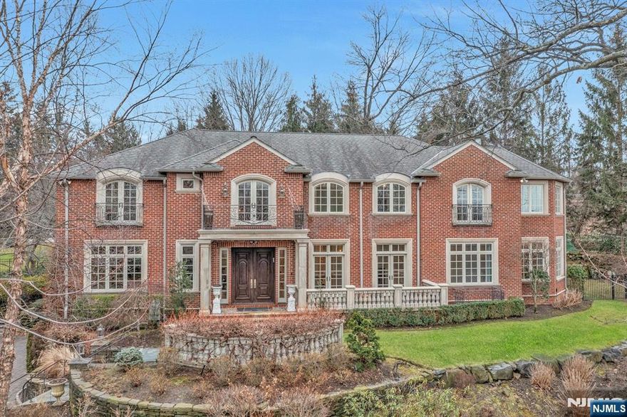 Set atop the East Hill of Cresskill sits this majestic all brick custom colonial. This European-style manor encompasses over 6000 square feet of expert detailing and features 6 bedrooms , 8 baths and a custom elevator. Enter the dramatic 2- story foyer with its sweeping staircase as light pours in the expansive setting. Adjacent is the living room and banquet-sized dining room with french doors leading to private balcony for elegant entertaining. The wood paneled library boasts custom built-ins as well as intricate detailed ceiling. Step into the grand great room complete with wood-burning fireplace, floor-to-ceiling windows and coffered ceiling. The gourmet chef's kitchen is fitted with stainless appliances, including separate refrigerator and freezer with french door access to outdoor private patio. Adjoining is the light-filled breakfast room as well as a sunroom and bedroom with full bath .Enter the grand primary suite on the 2nd level , boasting 2 full bathrooms and 2 custom closets ,fireplace, sitting room and private balcony. There are 3 additional bedroom ensuites for ample accommodations. Enjoy the finished lower level with large recreation room, gym ,bedroom and bath, laundry and multiple storage areas. Step outside and your private oasis awaits. Lush landscaped private grounds with sweeping stone patios adjoining the resort-style pool.This luxury retreat is minutes from Manhattan yet tucked away in this private enclave. A rare gem for the discerning buyer.