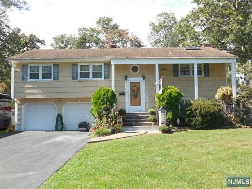 Must see not your average Bi-Level located in a nice quiet neighborhood. Main level is a nice & spacious open floorplan with a large living room& dining room, Master bedroom with a skylight & 1/2 bath, two more bedrooms, full bath & huge eat in kitchen with a skylight, tons of cabinet space, granite countertops & a separate 2nd staircase with a side door out & storage area above takes you down to the lower level family room with a wood burning fireplace, bedroom, 1/2 bath, laundry room & sliders to a large park like fenced in yard. Spacious 2 car garage with plenty of storage. Lower level has the perfect layout for an In-Law suite if needed.