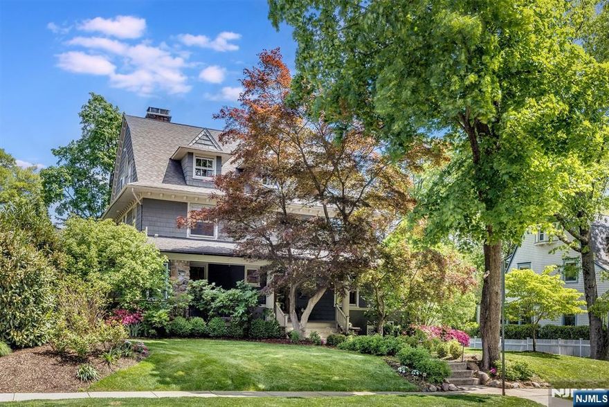 This exquisite Erwin Park Craftsman Colonial has gorgeous period architecture that blends seamlessly with modern updates & unique custom finishes. Step inside from the expansive front porch and you'll find details like period moldings, leaded glass, window seats & pocket doors throughout. Off the foyer is the library/den adorned w/intricate built-in shelves. The generous LR w/ beamed ceilings, woodburning fireplace & French doors leads to a sunny office, perfect for work-from-home w/separate sitting area, powder rm and direct entrance off of the front porch. The spacious DR flows into the beautifully designed chef's kitchen featuring high-end custom wood cabinetry, stunning quartzite counters, wolf range, 2 ovens, sub-zero fridge & separate eating area. Off the kitchen is a skylit sunroom w/ doors that open to the enchanting & private fully fenced yard w/ lushly planted gardens, stone patio and a veggie garden. Second floor boasts an elegant primary suite w/gorgeous ensuite bath, 3 additional bedrooms, a renovated hall bath & tons of closets. The full 3rd floor has 2 more bedrooms, a full bath & grand family room. Outside, you'll find a lovely cobblestone driveway & spectacular stone-walled gardens leading to a charming garage w/ EV charger wiring. Close to Edgemont Pk, MHS, MKA, Watchung Plaza shops, eateries & NYC transportation. A true Montclair gem meticulously maintained w/ many improvements!