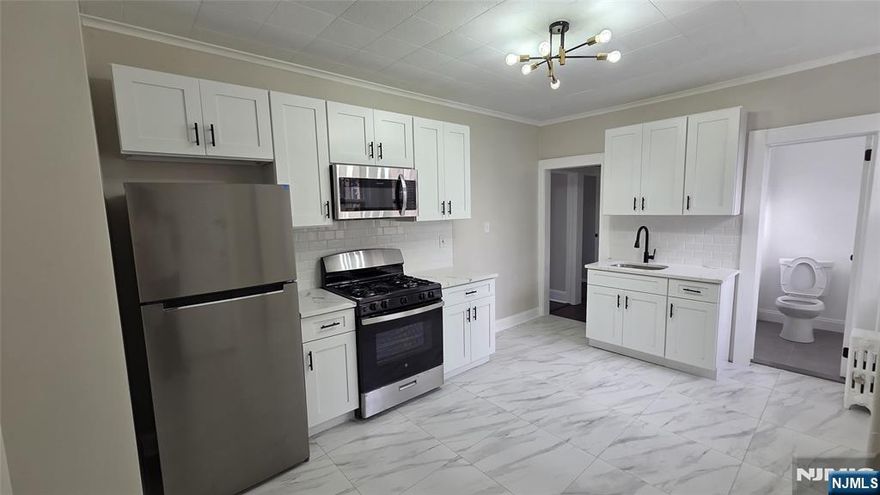 Don't miss out on this 1st floor, 2 bedroom apartment with so many benefits! Featuring a brand new, large, eat-in kitchen, with stainless steel appliances, built-in microwave, and gorgeous contemporary tile work, a freshly painted living room with newly sanded and stained hardwood floors, and beautifully updated bathroom with a stand up shower. Heat & Hot Water included in the rent! This unit has exclusive use of the backyard! Perfect for BBQing or just relaxing with friends and family. Conveniently located within walking distance to schools, shopping, dining, gyms, parks and more. This unit has in operated laundry in the basement, as well as extra storage, and on street parking. Close to public transportation, major highways, 2 miles from the Harrison Path train station providing easy access to NYC! Pets may be considered. Credit check and recent prior rental history a must.